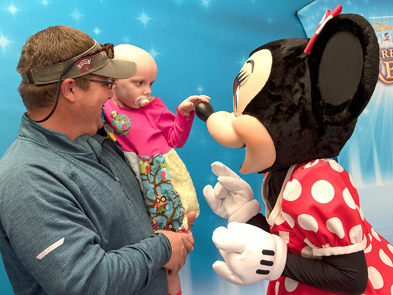 Lake Lindsey holds Iva Beth during a visit with Minnie Mouse at Batson Children’s Hospital in 2017.